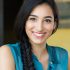 Closeup shot of young woman smiling. Portrait of brunette girl looking at camera and smiling. Shallow depth of field with focus on beautiful young happy girl with braid smiling.