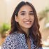 Closeup face of happy smiling young woman. Portrait of beautiful latin girl looking at camera. Confident casual girl sitting at cafeteria.